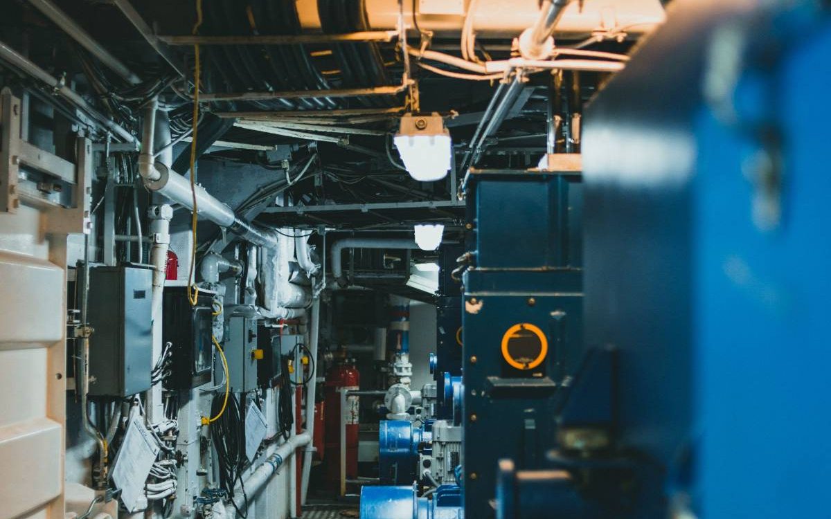 A commercial mechanical room: chillers, pumps and insulated piping.